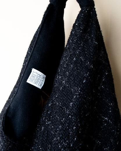 Vista laterale borsa Peggie con dettaglio reversibilità lamè e lana